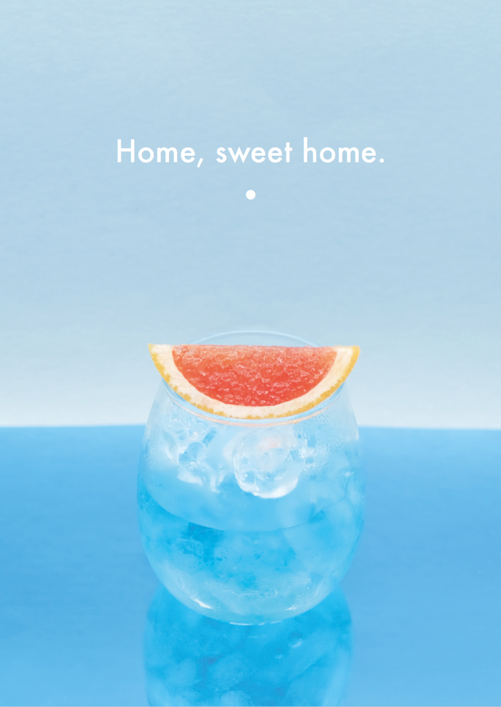drink decorated with grapefruit wedge and quote "Home, sweet home."